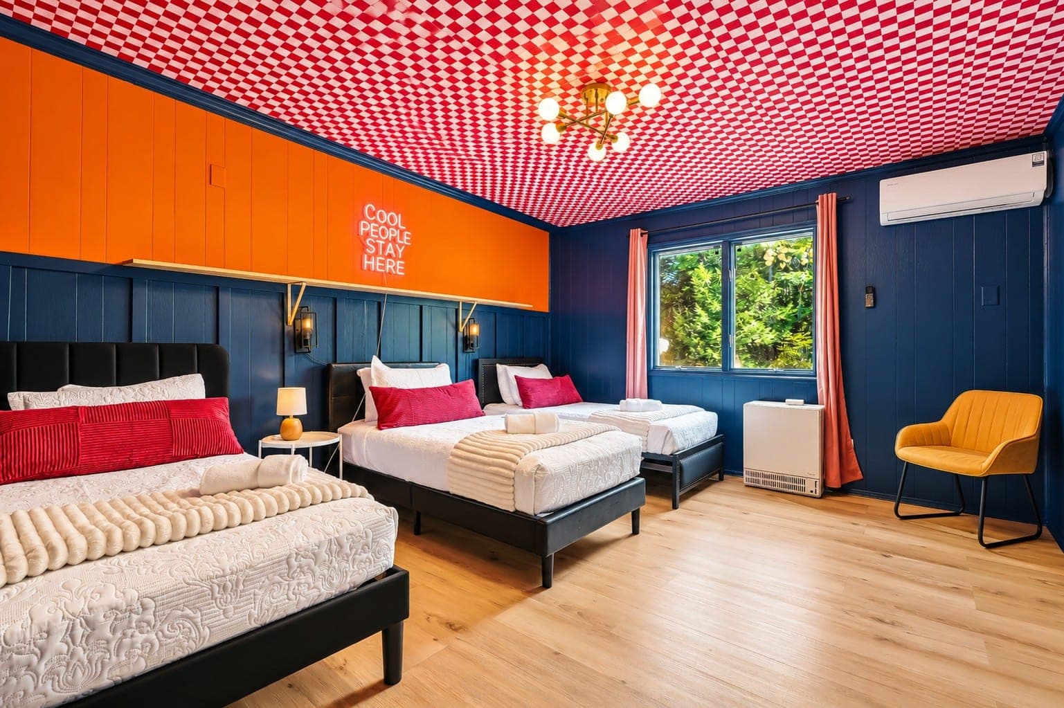 Bedroom with navy walls and a patterned ceiling