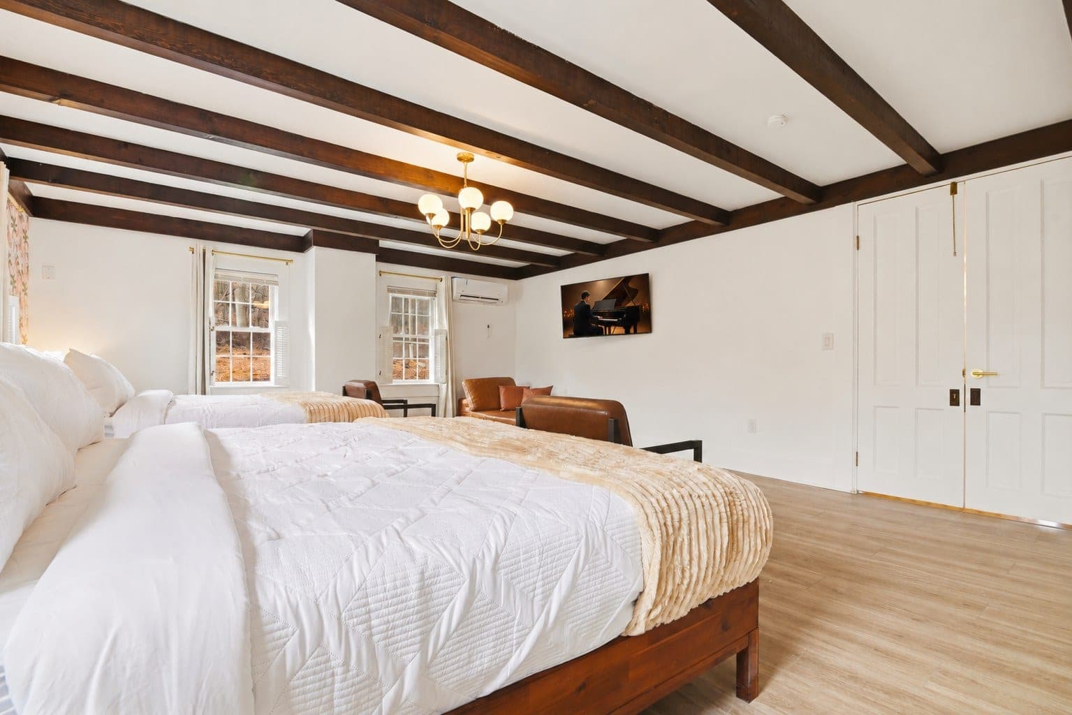 Bedroom 4 with a beamed ceiling and two beds
