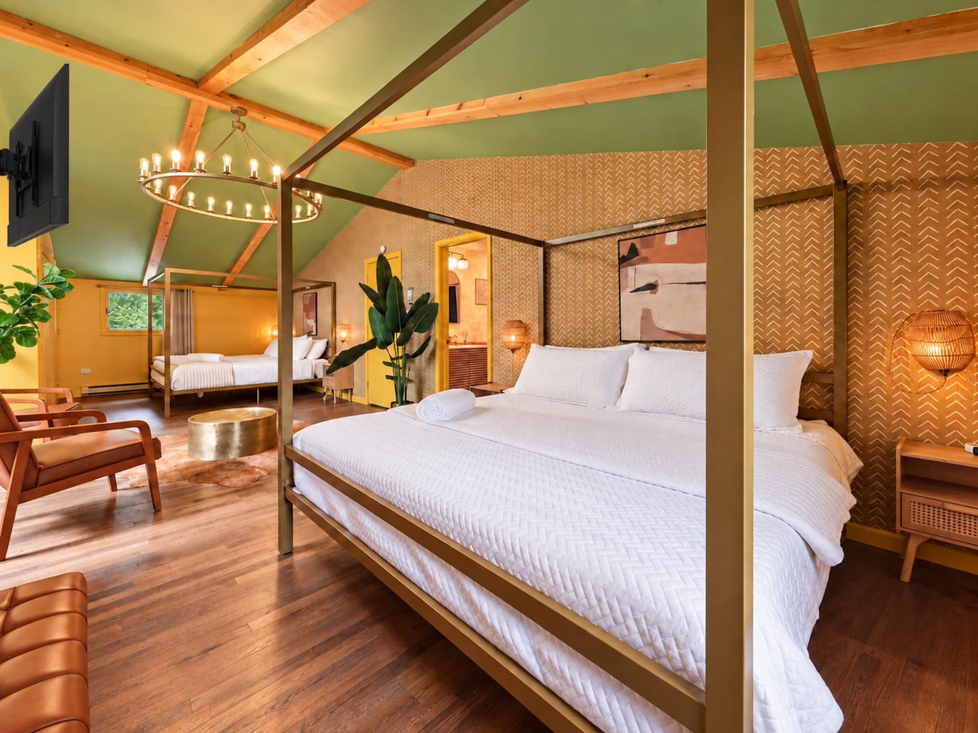 Bedroom with a four-poster bed and a sitting area