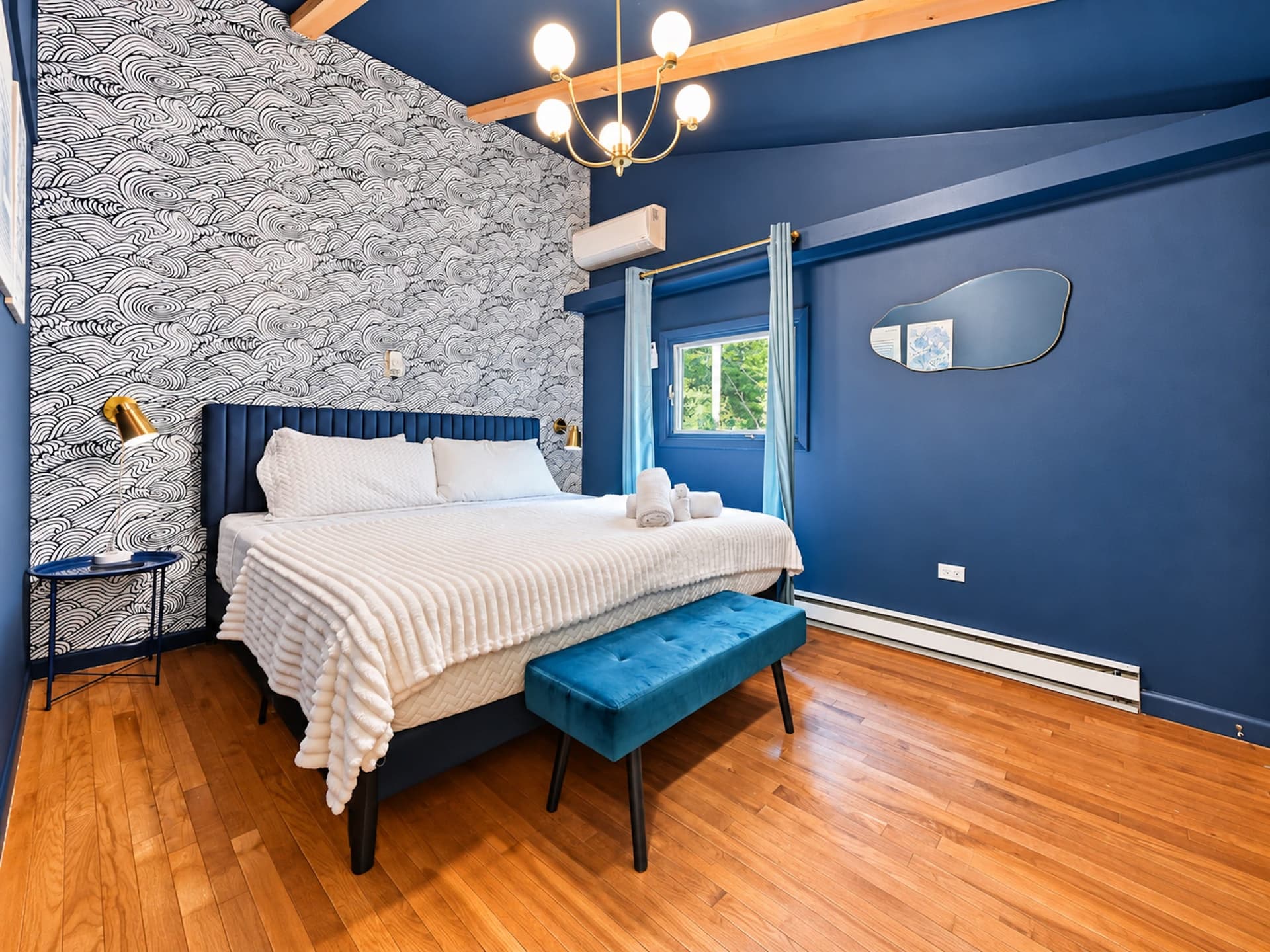 Navy blue bedroom with an upholstered bed