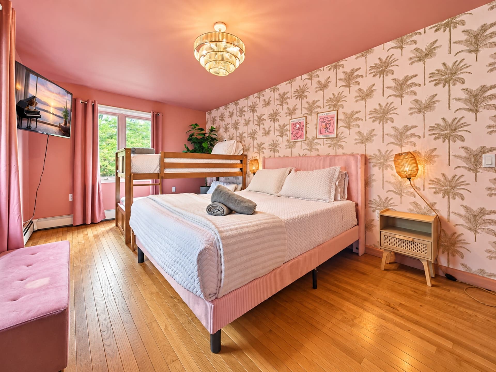 Pink bedroom with a queen bed and a bunk bed